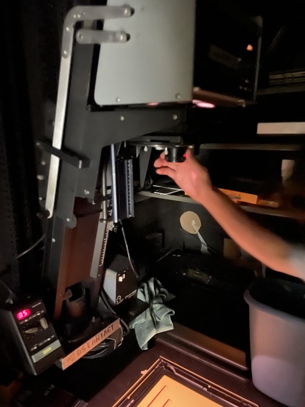 Person using the Super Chromega D enlarger in the color darkoom